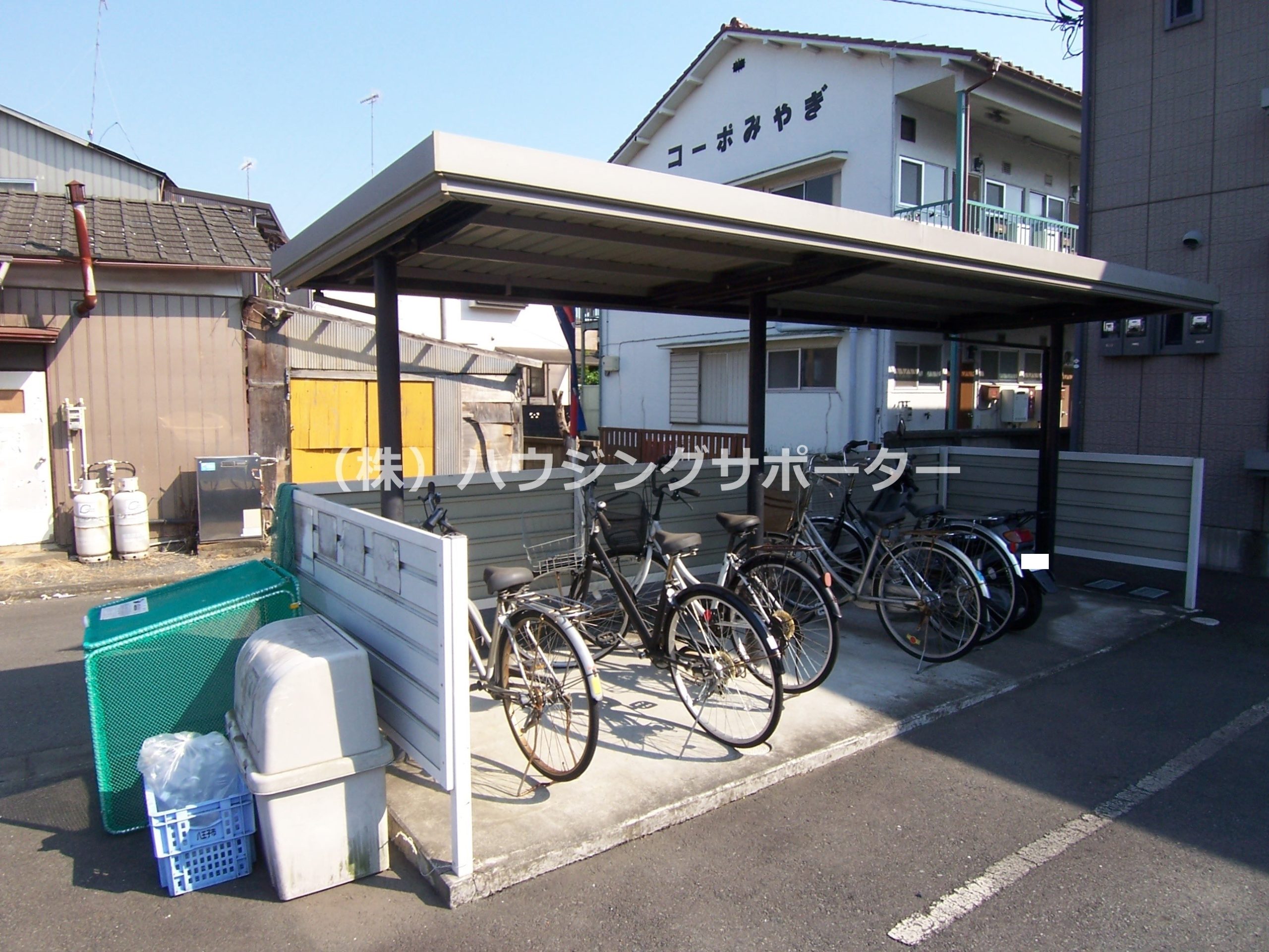 外観画像：敷地内ゴミ捨て場と駐輪スペースです